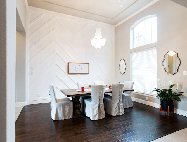 dining room featuring dark wood-type flooring and a high ceiling