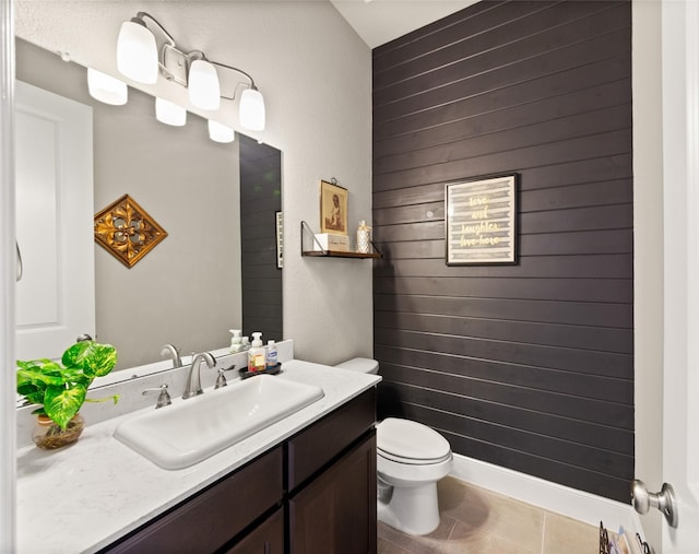 bathroom featuring toilet, vanity, and tile patterned floors