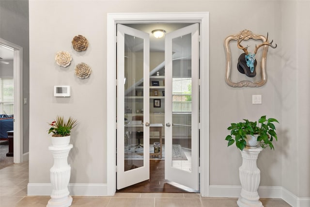 doorway to outside featuring tile patterned floors, french doors, and plenty of natural light