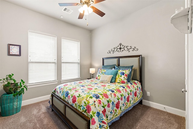 carpeted bedroom with multiple windows and ceiling fan