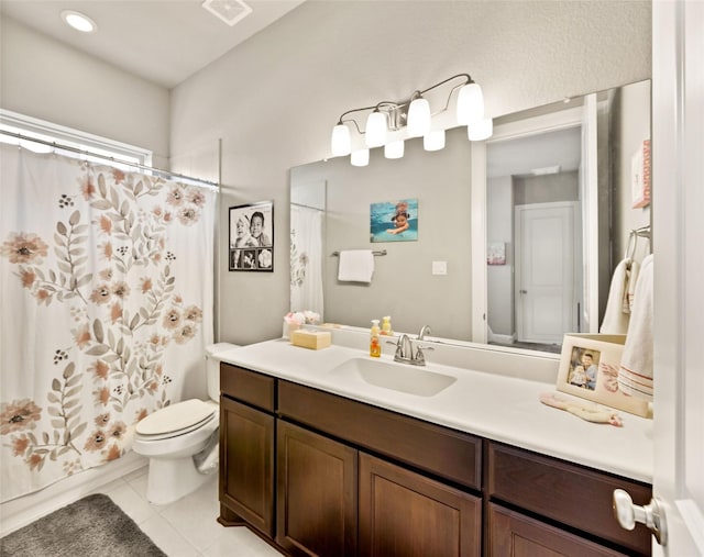 full bathroom with tile patterned floors, vanity, toilet, and shower / bath combo with shower curtain