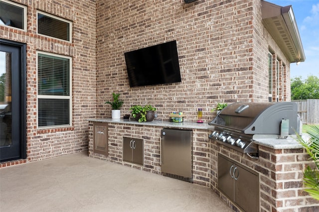 view of patio / terrace with area for grilling and a grill