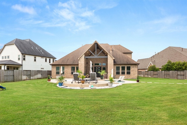 back of property featuring a yard and a patio