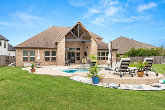 rear view of property featuring a yard, a fenced in pool, and a patio