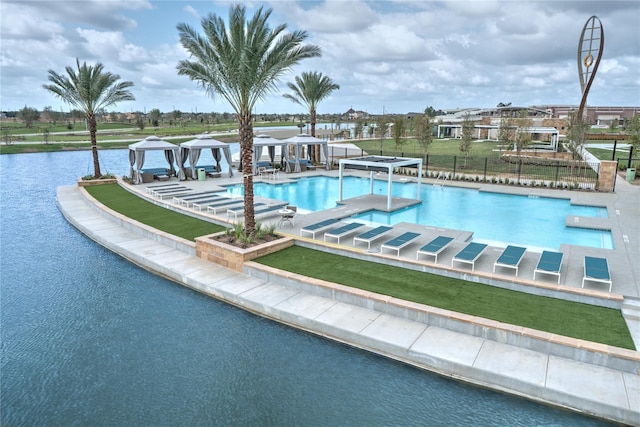 view of pool featuring a gazebo and a water view