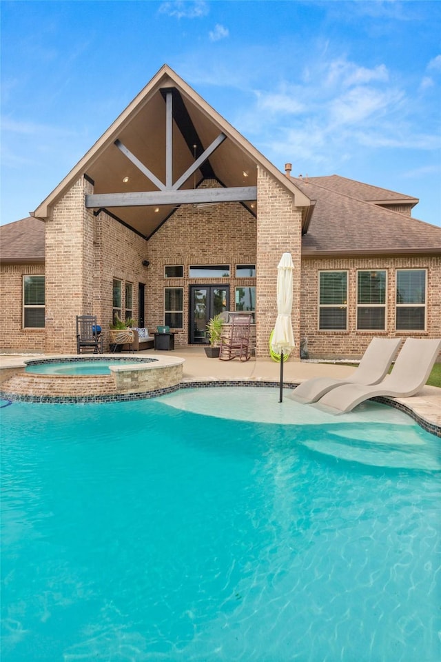 view of pool featuring an in ground hot tub and a patio