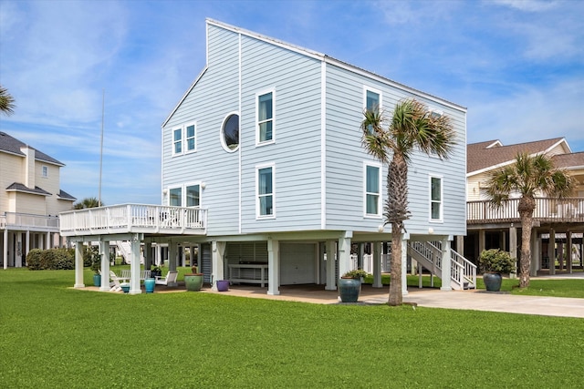 rear view of property with a carport and a yard