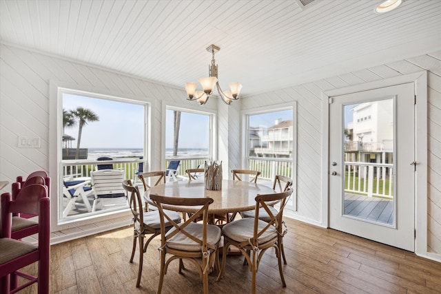 dining space featuring an inviting chandelier, hardwood / wood-style floors, and wooden ceiling