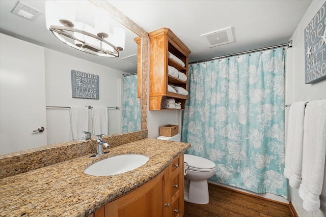 bathroom featuring hardwood / wood-style flooring, vanity, and toilet