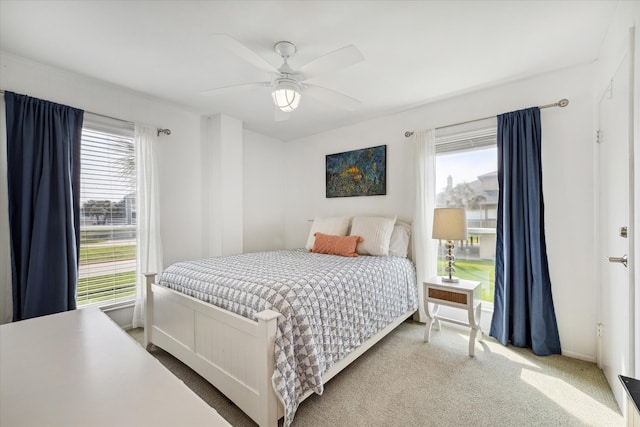 bedroom with ceiling fan and light carpet