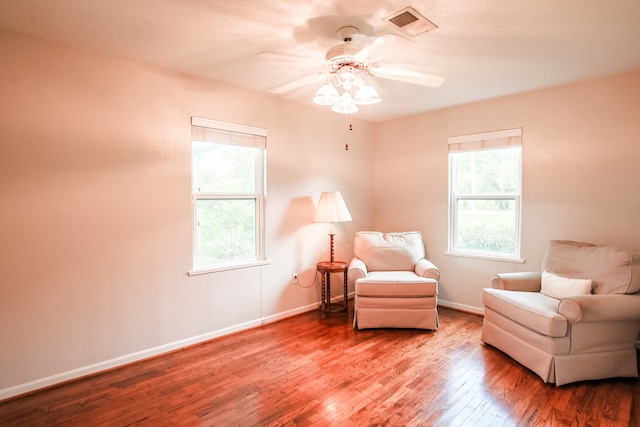 living area featuring ceiling fan and hardwood / wood-style flooring