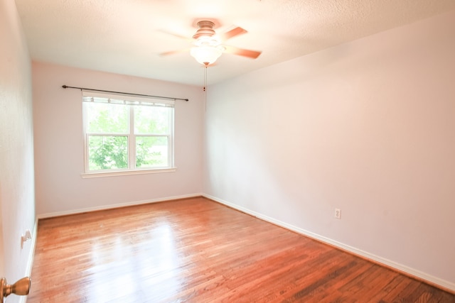 unfurnished room featuring ceiling fan and wood-type flooring