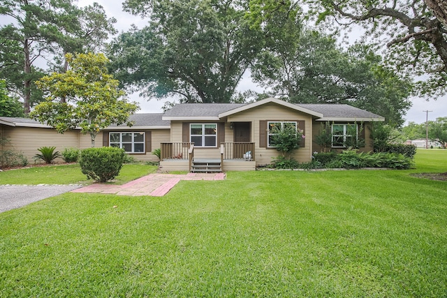 ranch-style home featuring a front yard