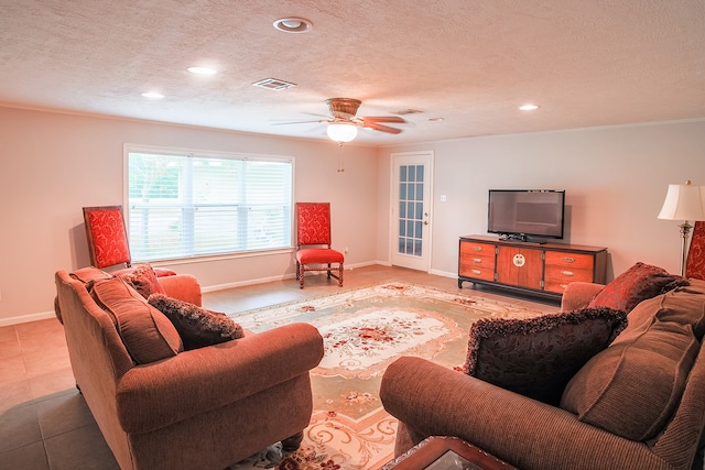 tiled living room featuring a textured ceiling and ceiling fan