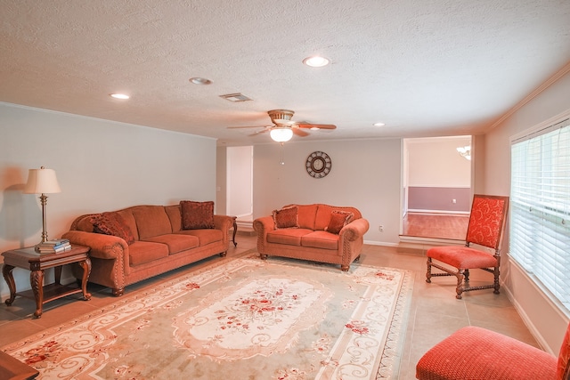 tiled living room with ceiling fan, a textured ceiling, and crown molding