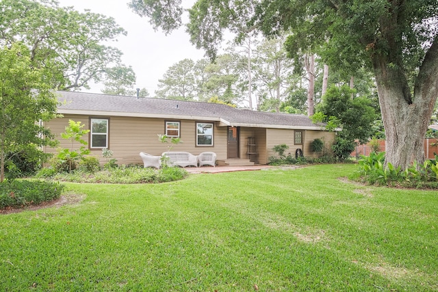 rear view of house with a yard