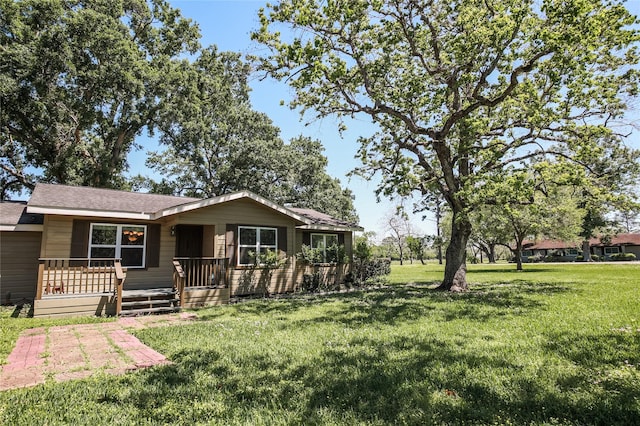 ranch-style home with a shingled roof and a front yard