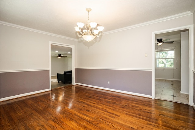 empty room with baseboards, ornamental molding, ceiling fan with notable chandelier, and wood finished floors