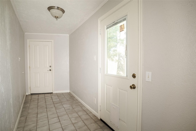 doorway featuring baseboards, ornamental molding, and light tile patterned floors