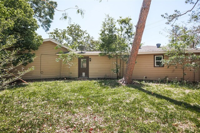 rear view of house with a yard