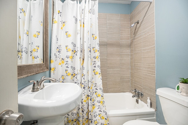 full bathroom with shower / bath combination with curtain, toilet, and sink