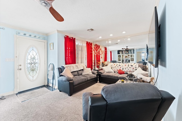 living room featuring ceiling fan, ornamental molding, and light carpet