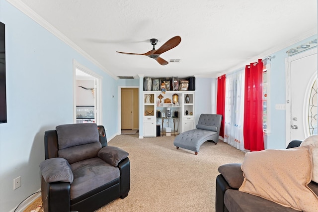 living room featuring light carpet, crown molding, ceiling fan, and a textured ceiling