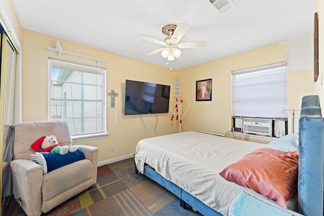 bedroom with ceiling fan, cooling unit, and a closet