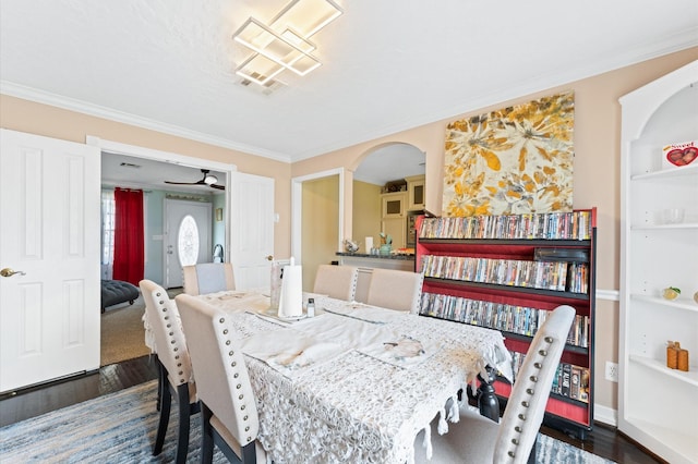 dining space with crown molding, ceiling fan, and dark hardwood / wood-style floors