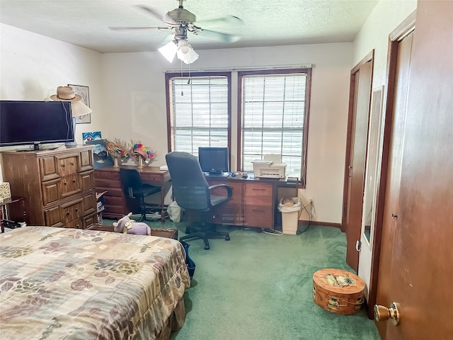 bedroom with carpet flooring, a textured ceiling, and ceiling fan