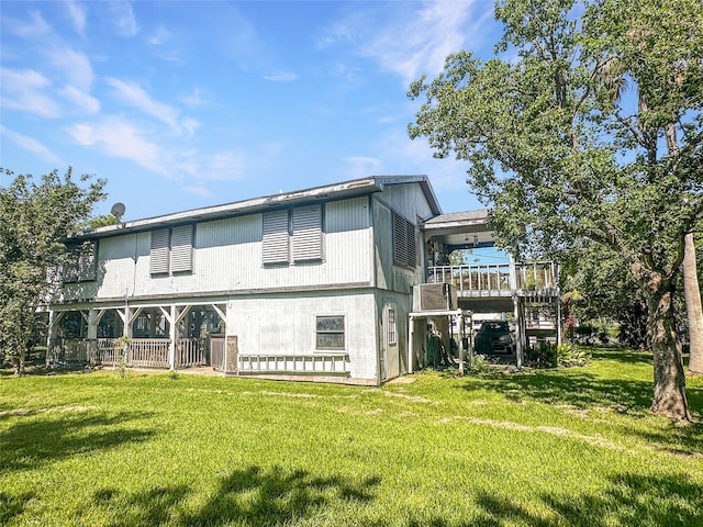 back of house with a wooden deck and a lawn