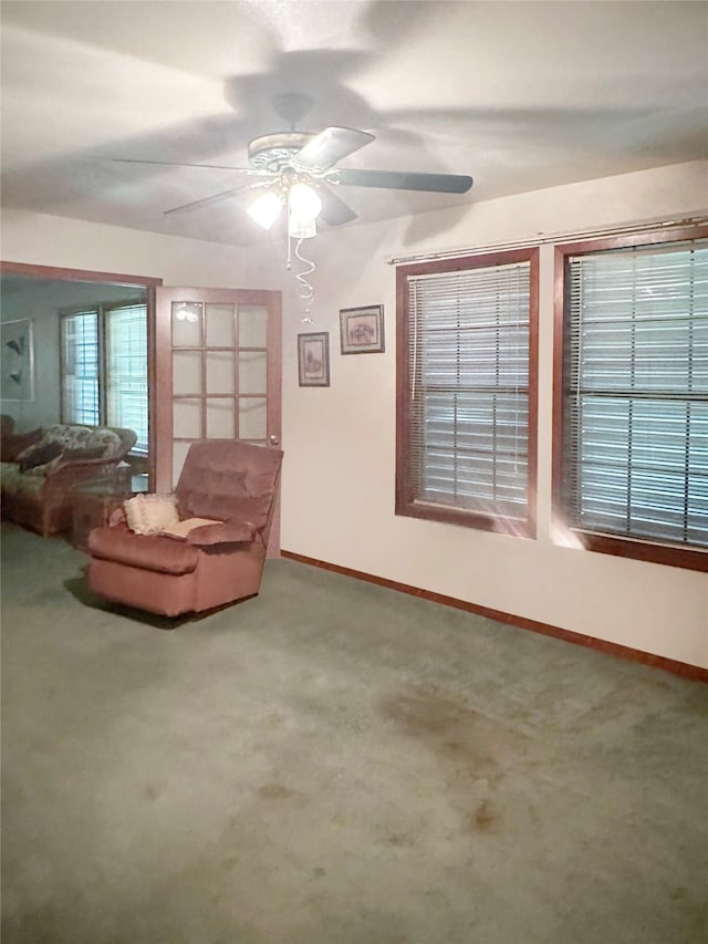 interior space featuring carpet flooring and ceiling fan