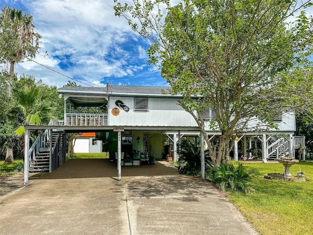 coastal inspired home featuring a carport and a front yard