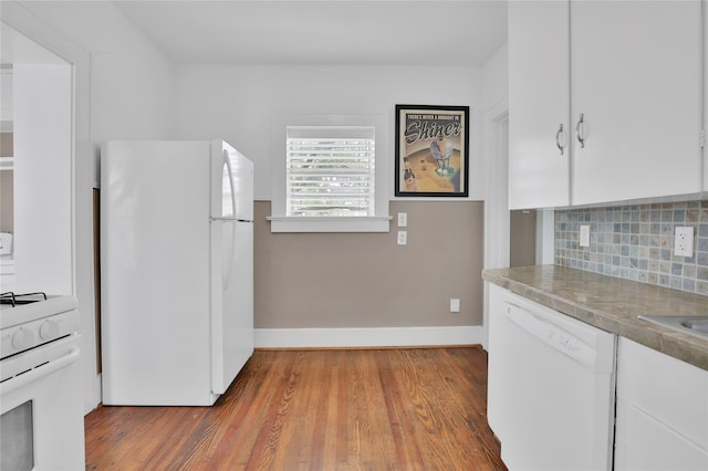 kitchen featuring backsplash, white cabinetry, white appliances, and light wood-type flooring