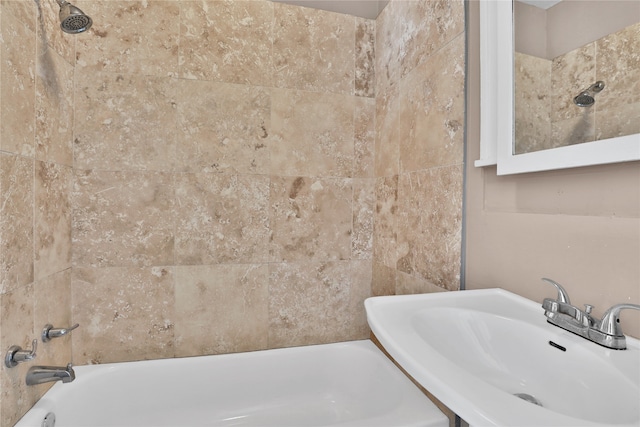 bathroom with sink and tiled shower / bath combo