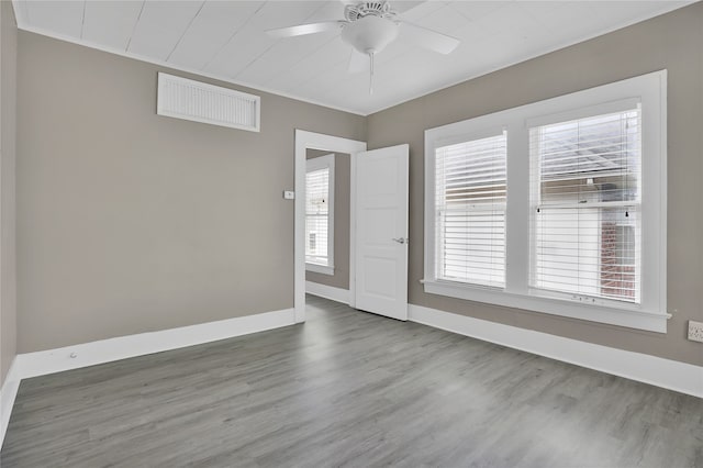 spare room featuring ceiling fan and dark hardwood / wood-style flooring