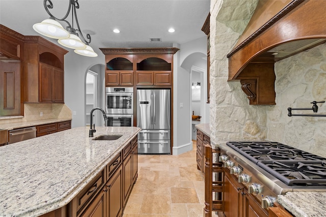 kitchen with light stone countertops, tasteful backsplash, light tile flooring, hanging light fixtures, and appliances with stainless steel finishes