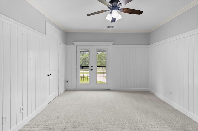 spare room featuring light carpet, ceiling fan, french doors, and crown molding