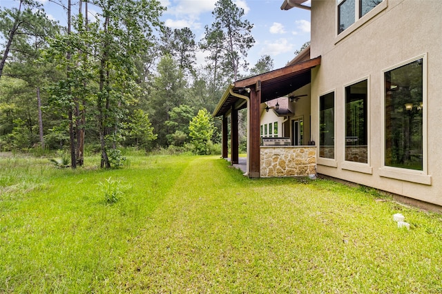 view of yard featuring ceiling fan