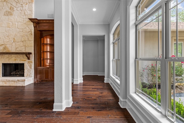 hallway featuring crown molding, a wealth of natural light, and dark hardwood / wood-style floors