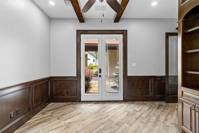 interior space featuring beam ceiling, ceiling fan, light hardwood / wood-style floors, and french doors