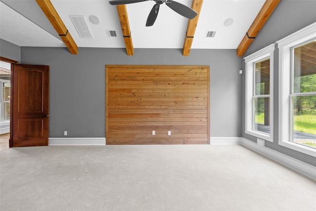 spare room with vaulted ceiling with beams, carpet, and ceiling fan