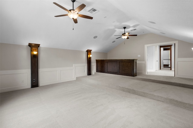 additional living space with ceiling fan, vaulted ceiling, and light colored carpet