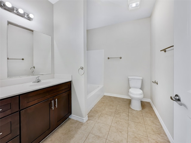 bathroom featuring tile flooring, toilet, and vanity