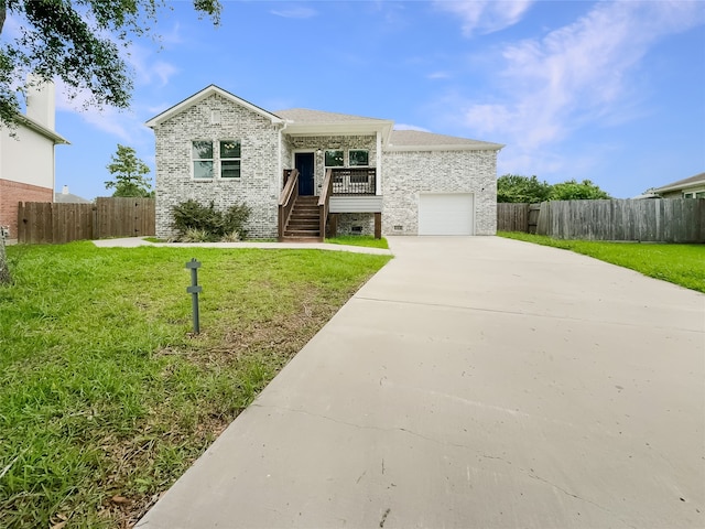 view of front of house with a front yard and a garage