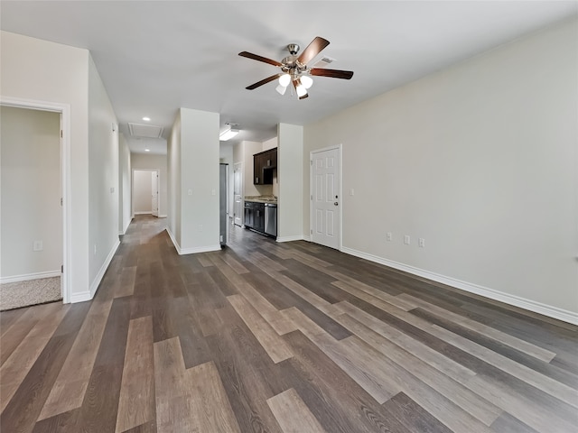 unfurnished living room with ceiling fan and dark wood-type flooring