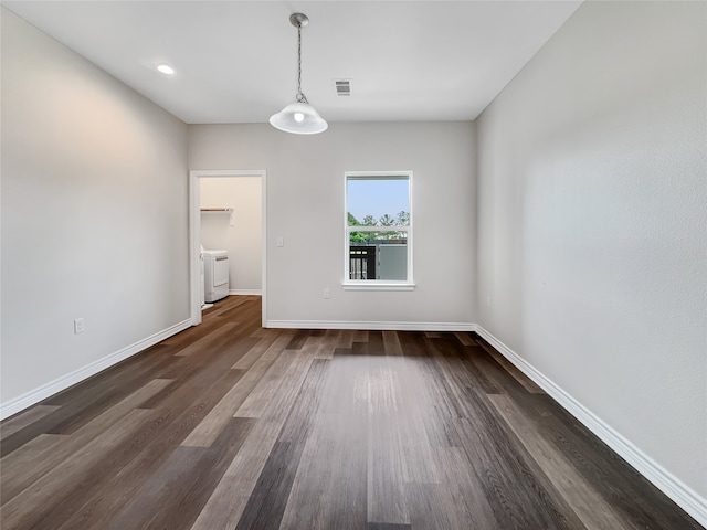 empty room with dark hardwood / wood-style floors and washer / clothes dryer