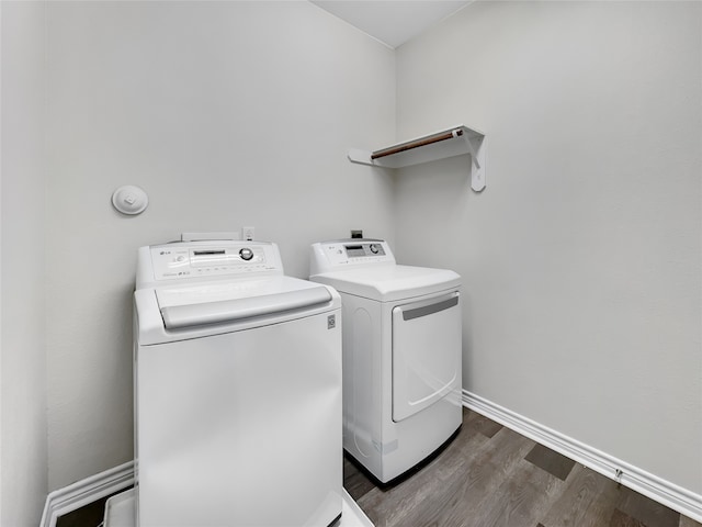 washroom with dark hardwood / wood-style floors and washer and dryer