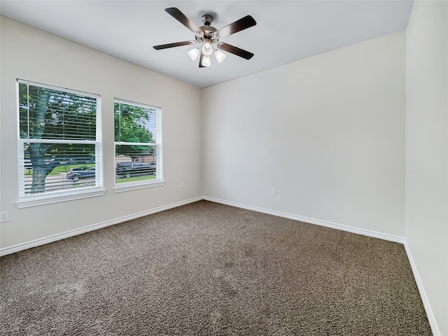 spare room featuring ceiling fan and carpet floors