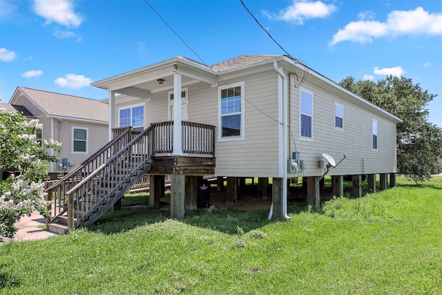 back of property featuring a yard